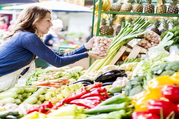 Woman selecting packaged produce at market